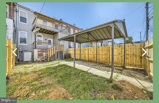 view of yard featuring central AC and fence