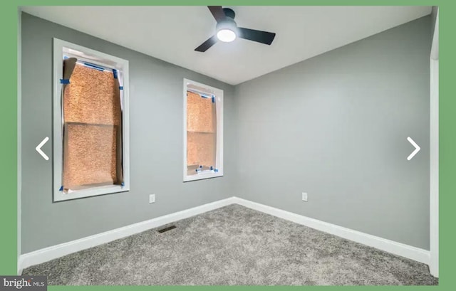 carpeted spare room featuring visible vents, baseboards, ceiling fan, and vaulted ceiling