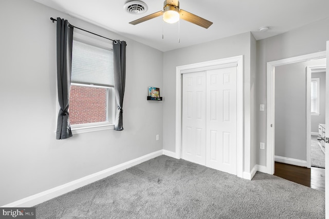 unfurnished bedroom featuring visible vents, baseboards, carpet floors, and a closet