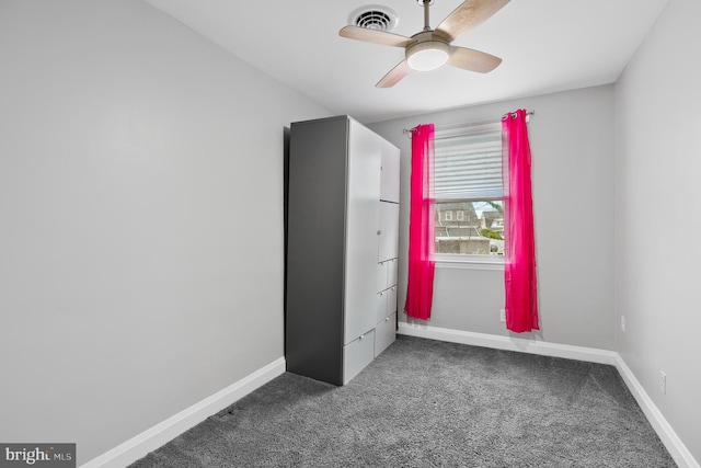 unfurnished bedroom featuring carpet flooring, baseboards, visible vents, and ceiling fan