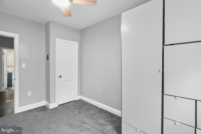 unfurnished bedroom with baseboards, carpet floors, and a ceiling fan
