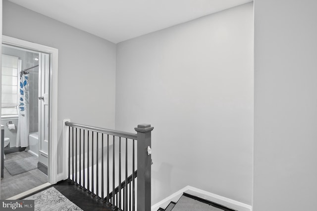 stairs featuring baseboards and wood finished floors