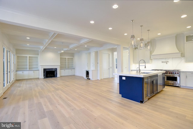 2762A Bon Haven Ln, Annapolis, MD 21401 - kitchen featuring a ceiling fan, light countertops, a sink, premium range hood, and designer stove