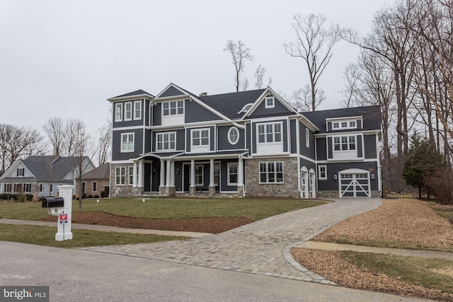 2762A Bon Haven Ln, Annapolis, MD 21401 - view of front facade with an attached garage, stone siding, a front lawn, and decorative driveway