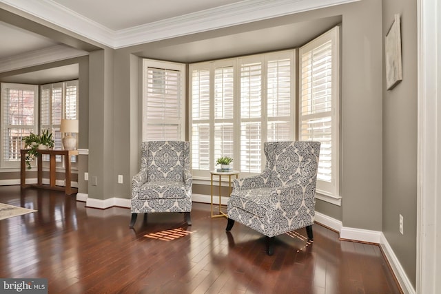 living area featuring baseboards, crown molding, and hardwood / wood-style floors