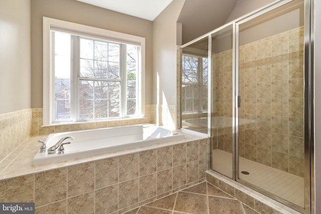 full bathroom with tile patterned flooring, a stall shower, and a garden tub