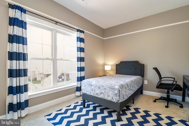 carpeted bedroom featuring baseboards