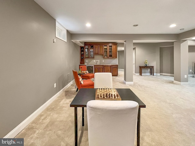 dining area with indoor wet bar, wine cooler, recessed lighting, and light colored carpet