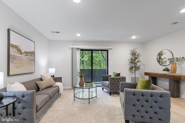 living area with visible vents, recessed lighting, light wood-style flooring, and baseboards