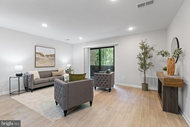 living room featuring recessed lighting, baseboards, visible vents, and light wood-style floors