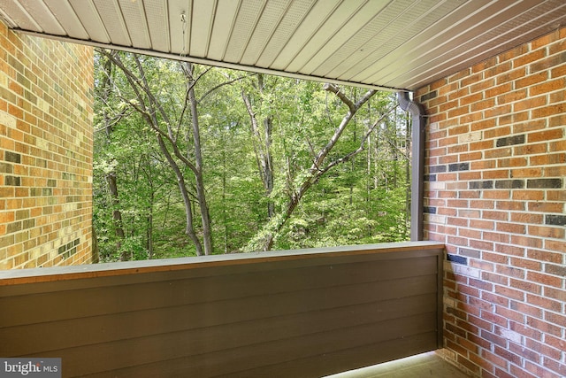 balcony featuring a wooded view