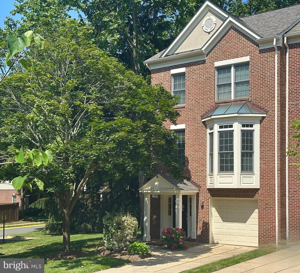 4042 Werthers Ct, Fairfax, VA 22030 - view of front facade featuring concrete driveway, brick siding, an attached garage, and a shingled roof