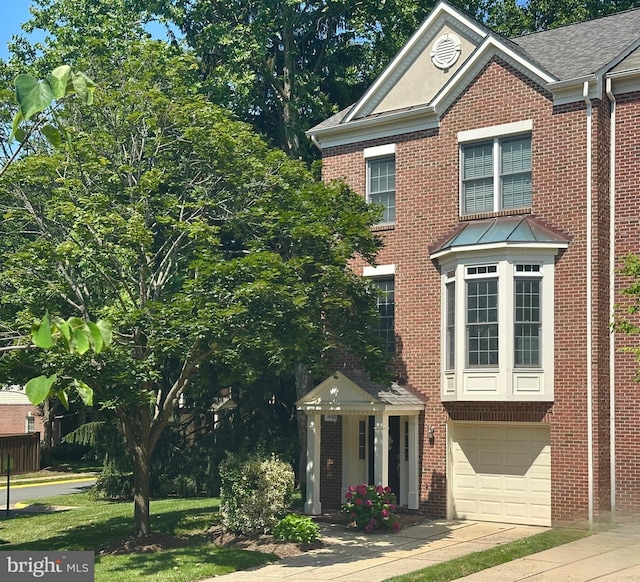 4042 Werthers Ct, Fairfax, VA 22030 - view of front facade featuring concrete driveway, brick siding, an attached garage, and a shingled roof