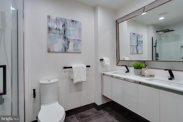 811 4th St NW Unit 608, Washington, DC 20001 - full bathroom featuring double vanity, toilet, a shower with shower door, and baseboards