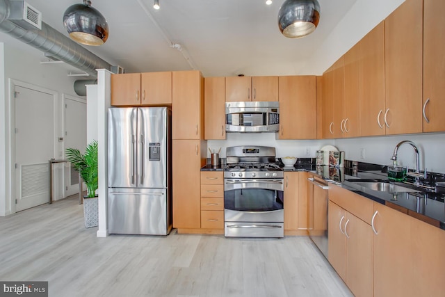 811 4th St NW Unit 608, Washington, DC 20001 - kitchen featuring stainless steel appliances, a sink, light wood-style floors, and light brown cabinets