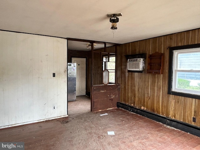 spare room with an AC wall unit and a baseboard radiator