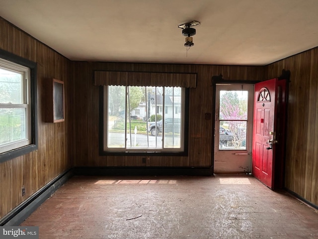 spare room featuring wood walls