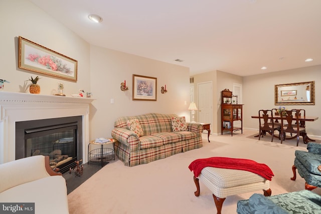 living room with a glass covered fireplace, carpet, baseboards, and recessed lighting