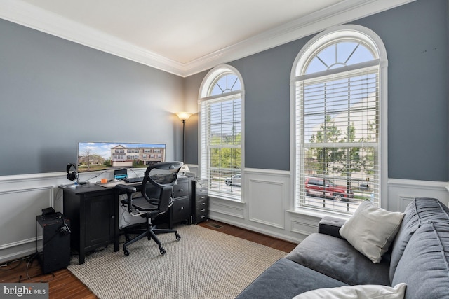 office with ornamental molding, wood finished floors, and a wainscoted wall