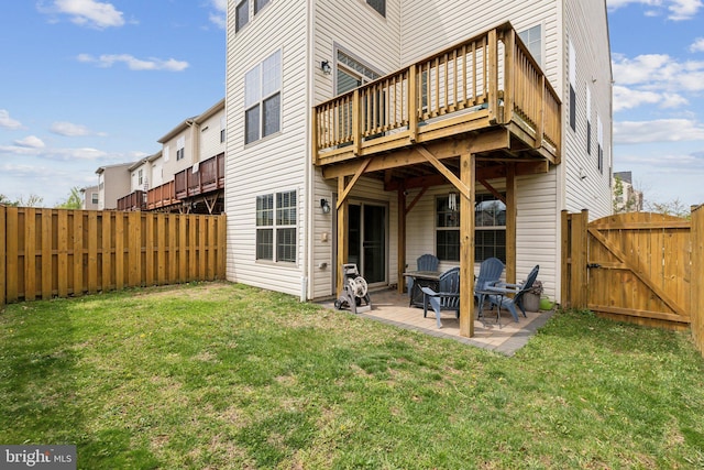 rear view of house featuring a deck, a fenced backyard, a gate, a patio area, and a yard