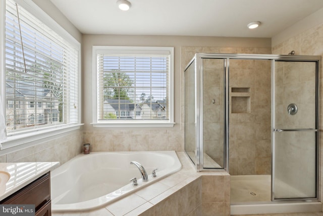 bathroom with vanity, a shower stall, and a bath