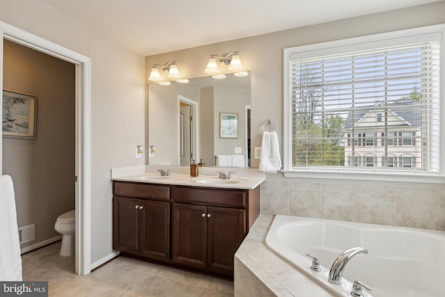 full bath with plenty of natural light, a sink, and a bath