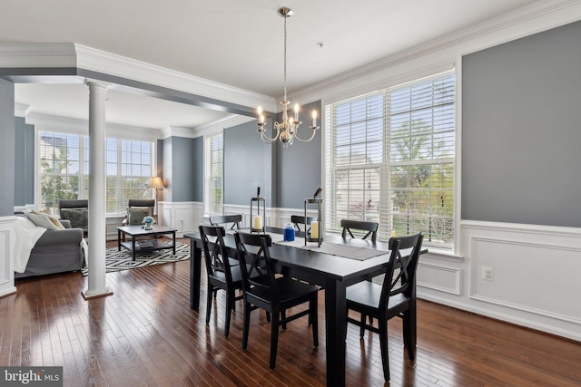 dining space featuring ornamental molding, wainscoting, dark wood-style flooring, and a decorative wall
