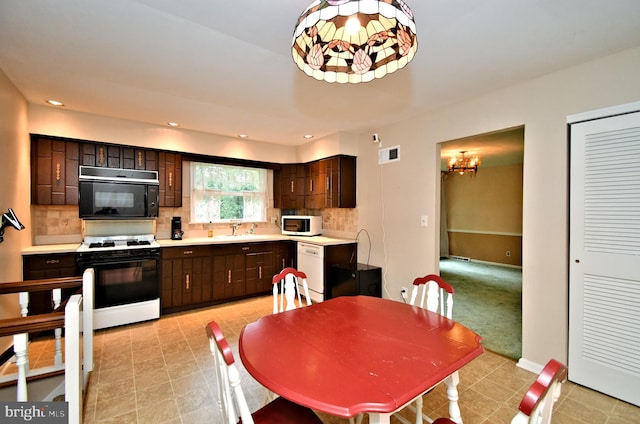40 Brookside Dr, Holland, PA 18966 - kitchen featuring white appliances, dark brown cabinetry, decorative backsplash, light countertops, and recessed lighting