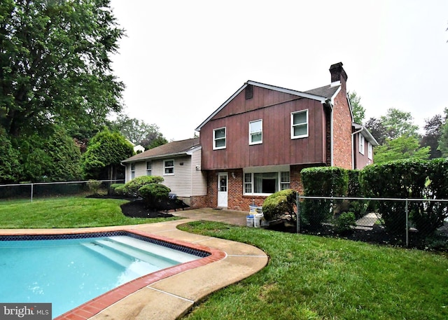 40 Brookside Dr, Holland, PA 18966 - rear view of property featuring a chimney, brick siding, and a fenced backyard