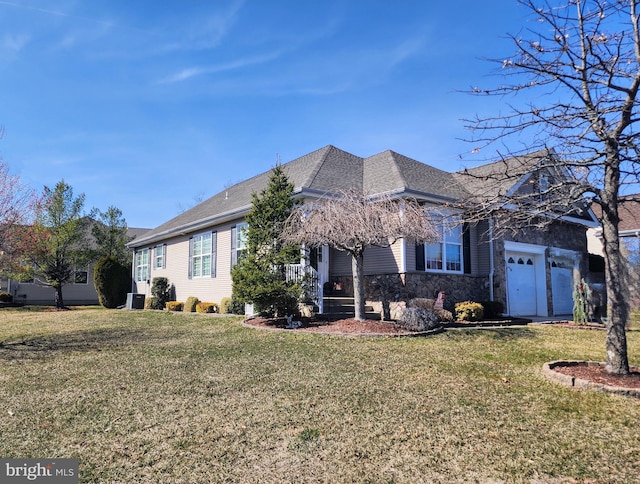 view of front of house featuring stone siding, a garage, roof with shingles, and a front lawn
