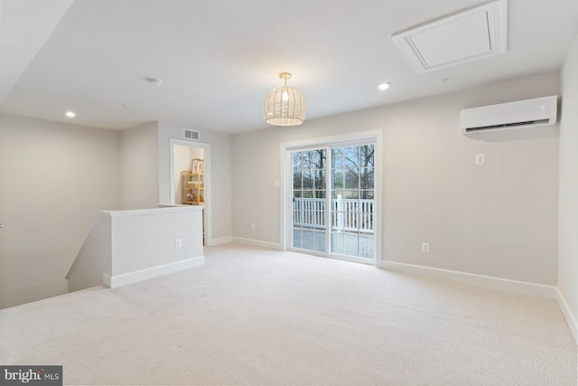 unfurnished room with recessed lighting, an AC wall unit, baseboards, visible vents, and light carpet