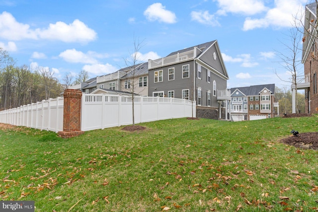 view of yard with a residential view and fence