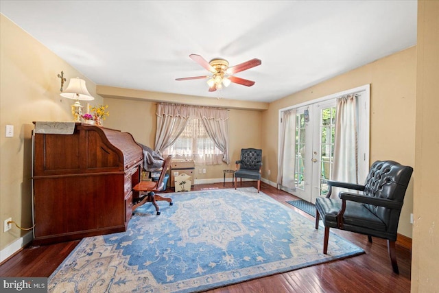 interior space with a ceiling fan, baseboards, plenty of natural light, and wood finished floors