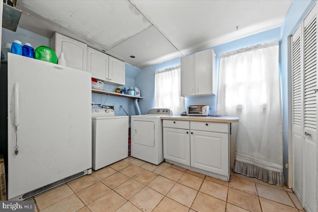 laundry area with separate washer and dryer, laundry area, light tile patterned flooring, and a toaster