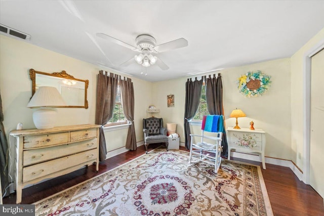 living area featuring a healthy amount of sunlight, a ceiling fan, wood finished floors, and visible vents