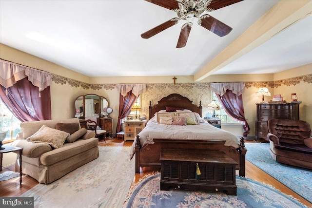 bedroom featuring multiple windows, a ceiling fan, and wood finished floors