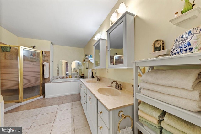 full bathroom with a sink, tile patterned flooring, a shower stall, and a garden tub