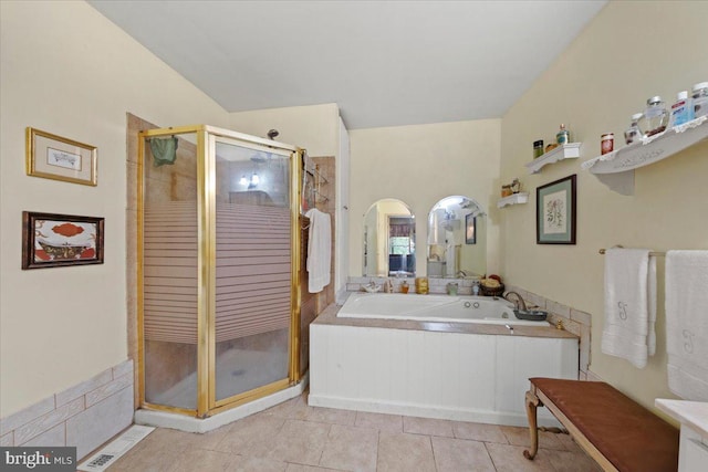 full bathroom featuring tile patterned floors, a shower stall, and a bath