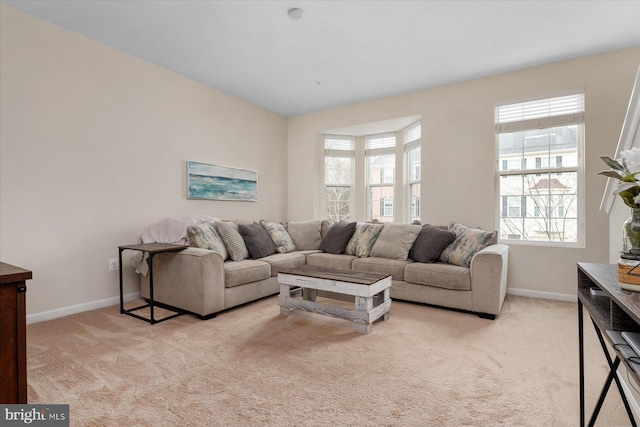 living room featuring baseboards and light carpet