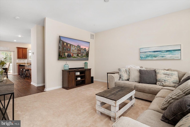 living room with light carpet, baseboards, visible vents, and recessed lighting