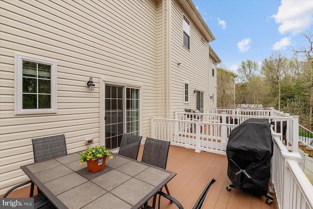 deck with grilling area and outdoor dining space