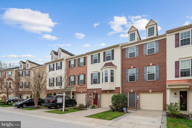 townhome / multi-family property with a residential view, driveway, and an attached garage
