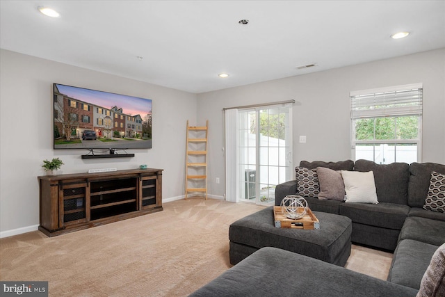carpeted living room with baseboards, visible vents, and recessed lighting