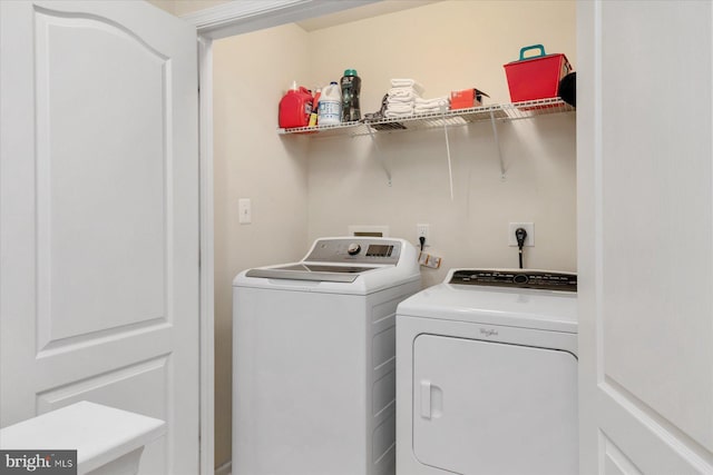 laundry area with washer and clothes dryer and laundry area