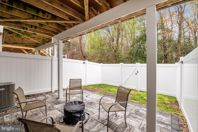 view of patio / terrace with a fenced backyard and central air condition unit