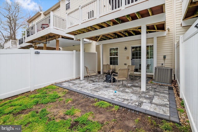 view of patio featuring cooling unit and fence