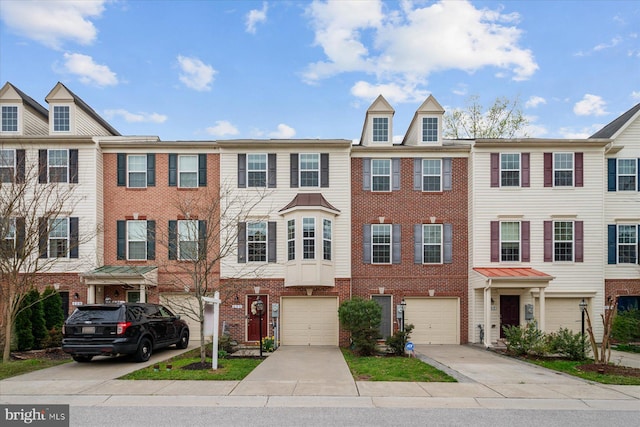 townhome / multi-family property with a garage, brick siding, and driveway
