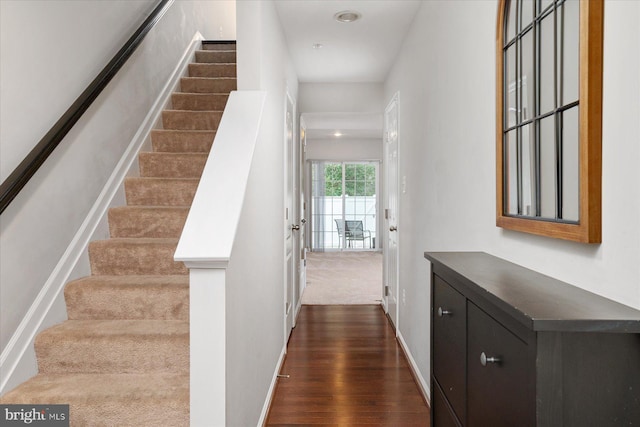 stairs featuring baseboards and wood finished floors