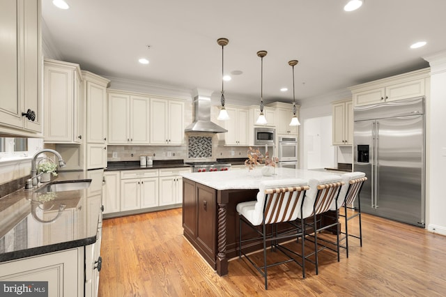 7521 Westfield Dr, Bethesda, MD 20817 - kitchen with built in appliances, wall chimney exhaust hood, a sink, light wood-style flooring, and recessed lighting