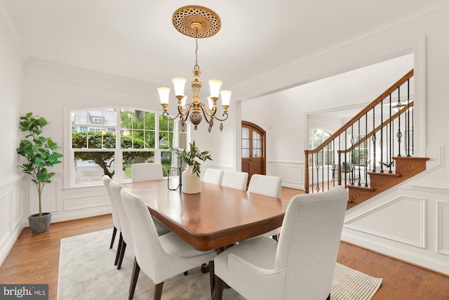7521 Westfield Dr, Bethesda, MD 20817 - dining room with a decorative wall, a chandelier, plenty of natural light, crown molding, and light wood-style flooring